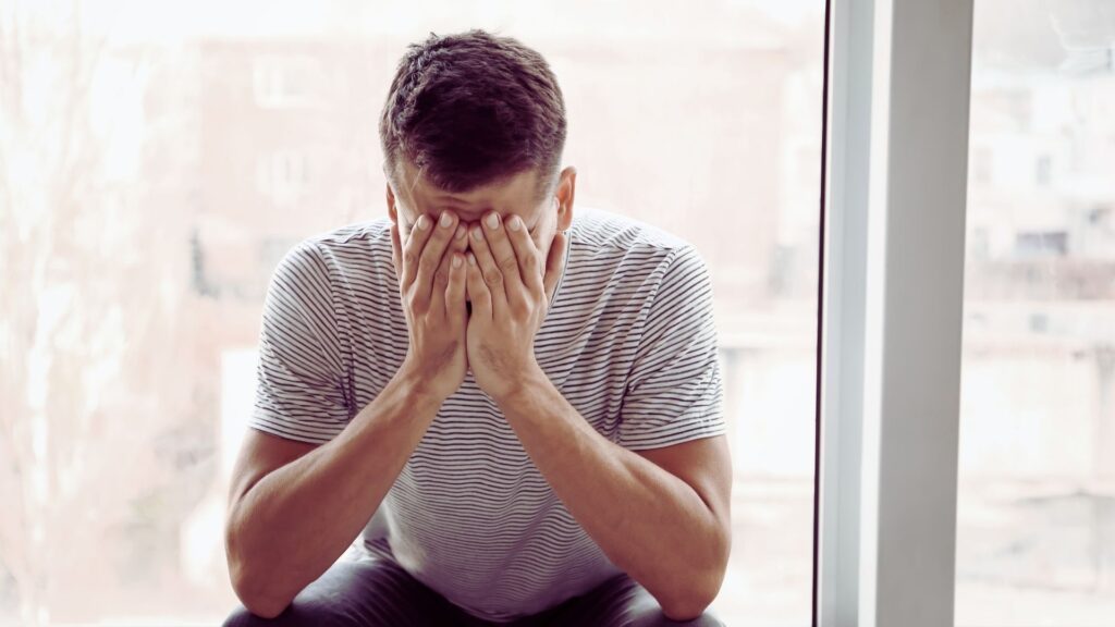 Man experiencing emotional distress related to alcohol and mental health